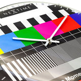 Close-up of the TV Testpage Round Dome Glass Wall Clock, 35cm, showing colour bars, black and white stripes, grid lines, slim silver hands and domed glass finish.
