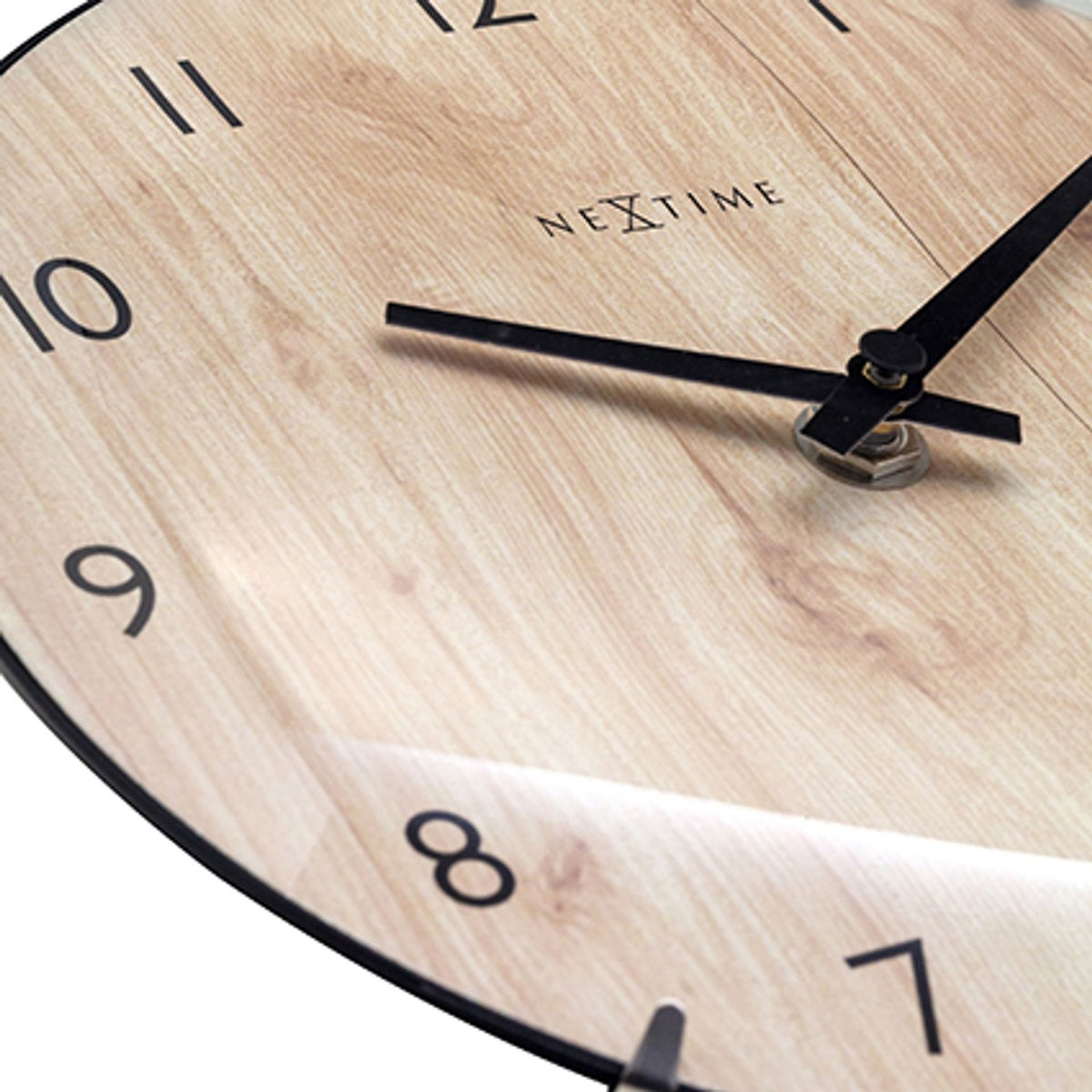 Close-up of the Edge Wood Mini Table or Wall Clock in brown, showing the light wood grain face, black numerals, and black hour and minute hands with a slim black rim.
