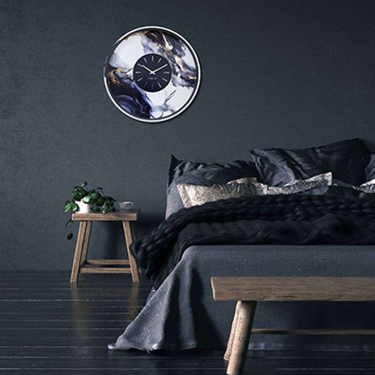 Marble Duo Round Aluminium Wall Clock 48cm in Silver & White, with a black centre dial and silver baton markers, shown on a dark bedroom wall above the bed.