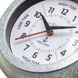 Close-up of the Tide Galvanised Wall Clock, 22cm round silver case with white dial, black numerals, blue High Tide/Low Tide text and anchor motif.