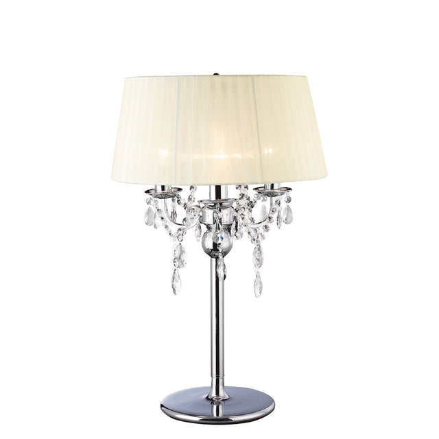 The Olivia 3 Light Crystal Table Lamp features a polished chrome base, hanging crystal accents, and an ivory cream shade, displayed on a plain white background.