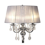 The Olivia 3 Light Crystal Table Lamp features a polished chrome base, hanging crystal accents, and a large round grey shade for soft ambient lighting.