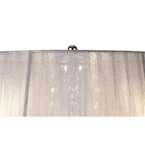 Close-up of the Olivia 3 Light Crystal Table Lamp in polished chrome, featuring a grey, slightly sheer lampshade and a chrome finial. The shade diffuses ambient lighting for a softly glowing effect.