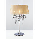 The Olivia 3 Light Crystal Table Lamp features a polished chrome finish, sparkling crystal accents, and a soft bronze shade, offering elegant, dimmable decorative lighting for any room.