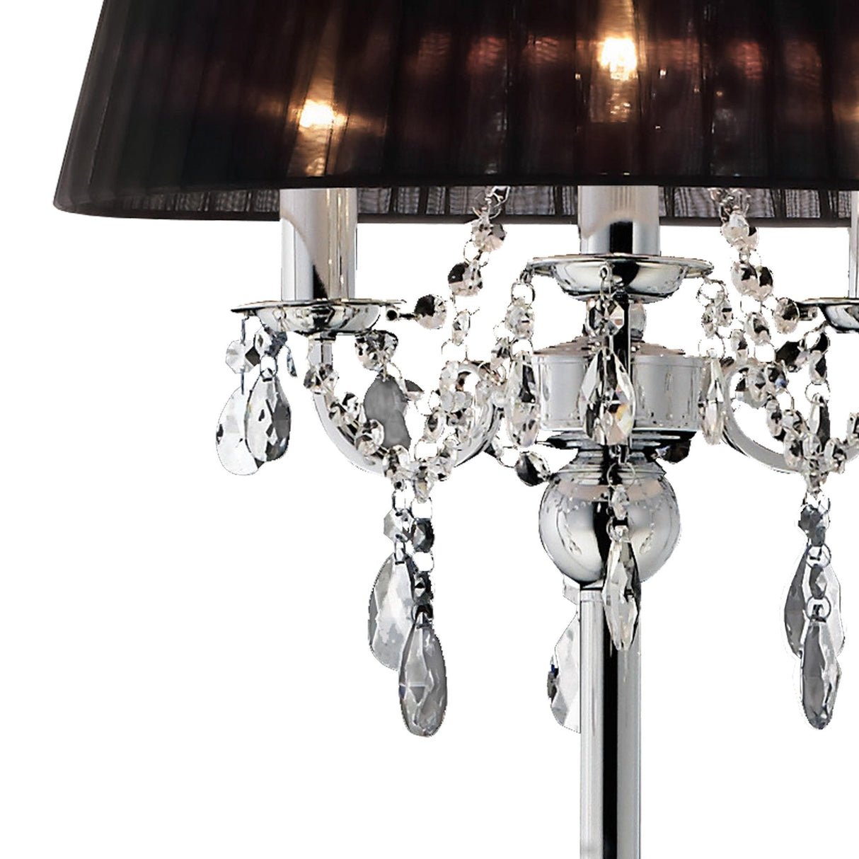 A close-up of the Olivia 3 Light Crystal Floor Lamp in chrome, featuring a black pleated shade and hanging crystal accents on a shiny base, softly illuminated with warm light.