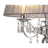 Close-up of the Olivia 3 Light Crystal Floor Lamp featuring a chrome arm, grey translucent shade, and hanging crystal ornaments, partially illuminated.