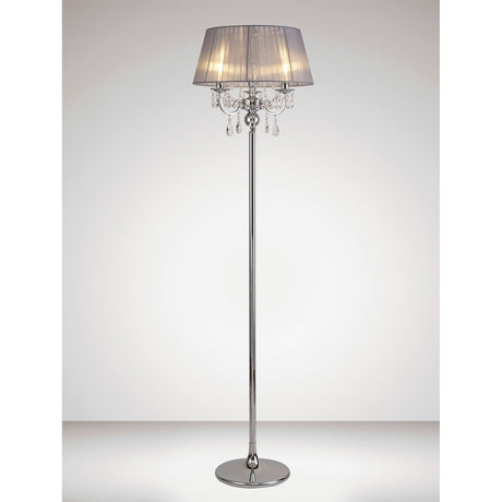 The Olivia 3 Light Crystal Floor Lamp features a chrome finish, grey shade, and hanging crystal accents, making it a modern addition to any softly lit room with a plain background.