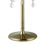 Close-up of the Olivia 3 Light Crystal Table Lamp in antique brass with a smooth, round base, slender pole, bronze shade, and hanging crystal ornaments that add subtle sparkle to this elegant design.