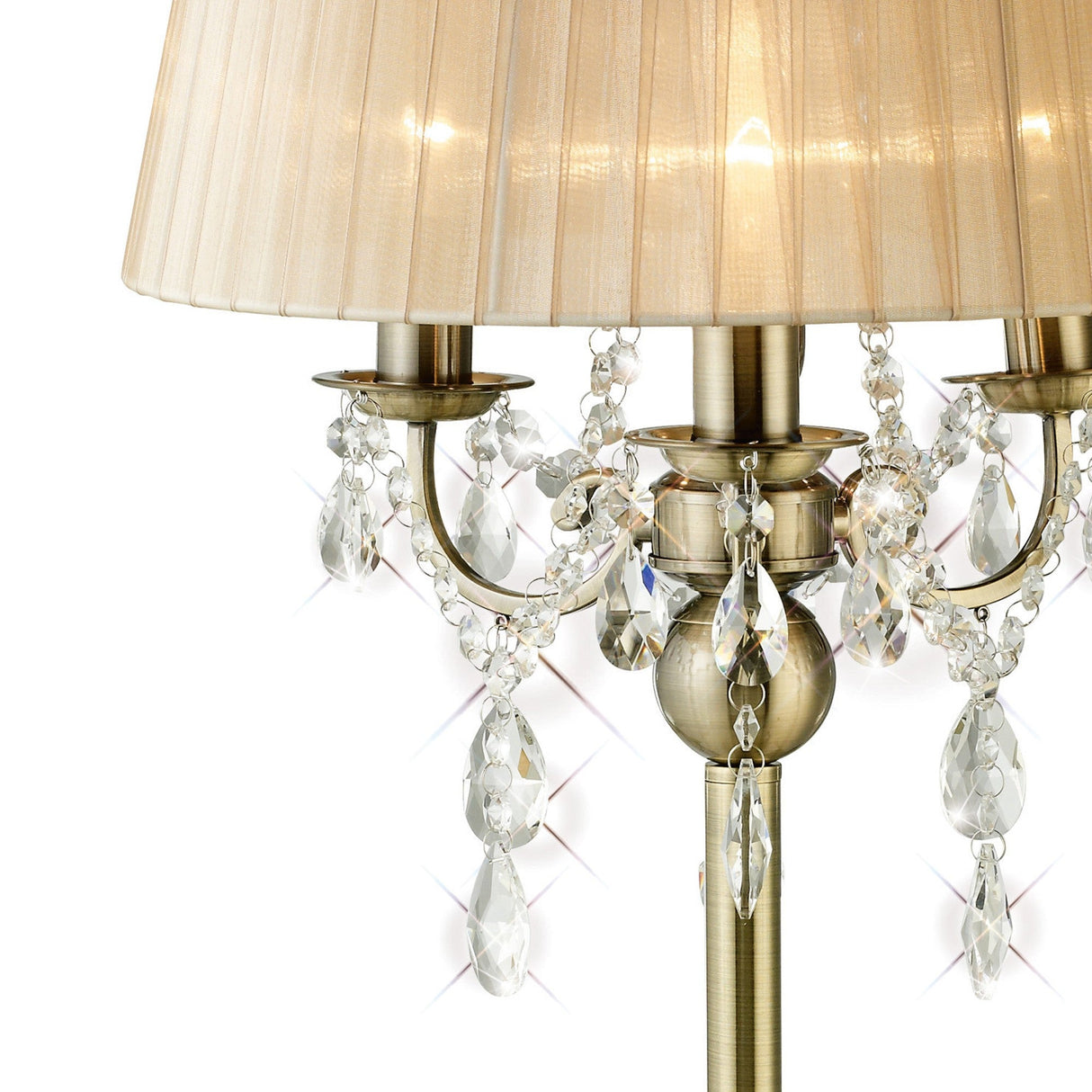The Olivia 3 Light Crystal Table Lamp features antique brass arms, sparkling hanging crystals, and a bronze shade, reflecting light for an elegant, timeless look.