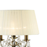 The Olivia 3 Light Crystal Floor Lamp features a brass finish, crystal accents, and a pleated cream shade, shown here in close-up against a plain white background.