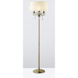 The Olivia 3 Light Crystal Floor Lamp features a tall antique brass frame, cream pleated shade, round base, and elegant hanging crystal accents, shown here against a simple light background.