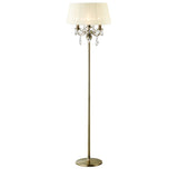 The Olivia 3 Light Crystal Floor Lamp features a brass finish, a round base, a cream pleated shade, and elegant crystal accents beneath the shade for a chandelier-inspired look.