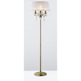 The Olivia 3 Light Crystal Floor Lamp features an antique brass finish, a round base, white pleated shade, and crystal accents hanging below the shade.