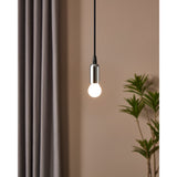 Pendant light with chrome fitting and lit opal LED golf ball bulb, E14 fitting, warm white glow, shown against a beige wall with curtain and plant.