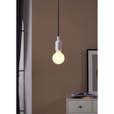 Pendant light fitted with an Opal LED globe bulb E27 G80, glowing warm white above a white chest of drawers in a neutral-toned room.