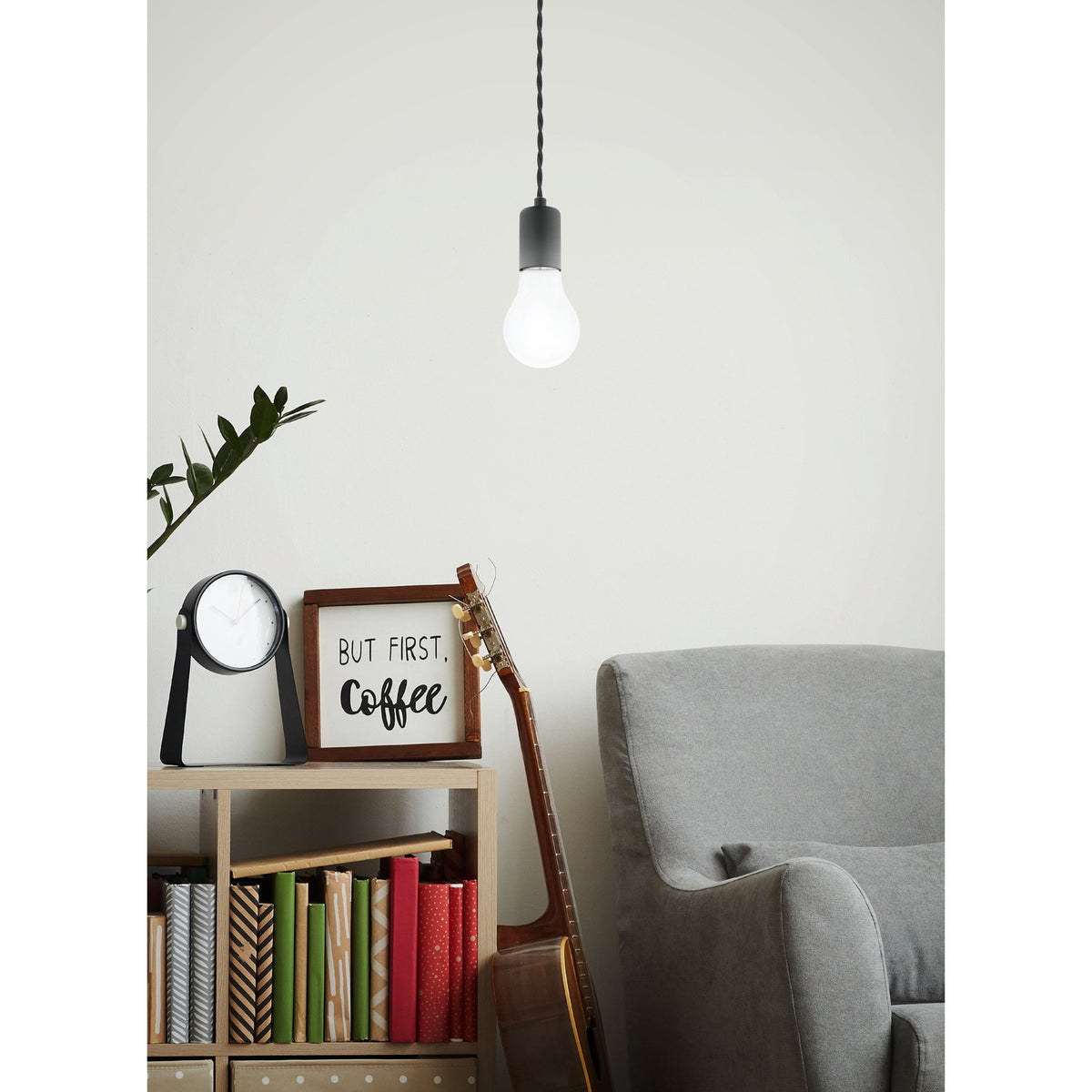 Opal LED GLS bulb with E27 screw cap and grey pendant holder, lit warm white above a bookshelf in a living room setting.