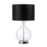 The Orb 1 Light Table Lamp features a modern, clear glass base paired with a round black shade. Polished nickel accents at both the base and top enhance its sleek design, making it an elegant choice for contemporary interiors.