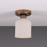 Osier Ceramic Flush Ceiling Light with a matt white striped bell-shaped shade and round brass ceiling plate, shown against a plain grey background.