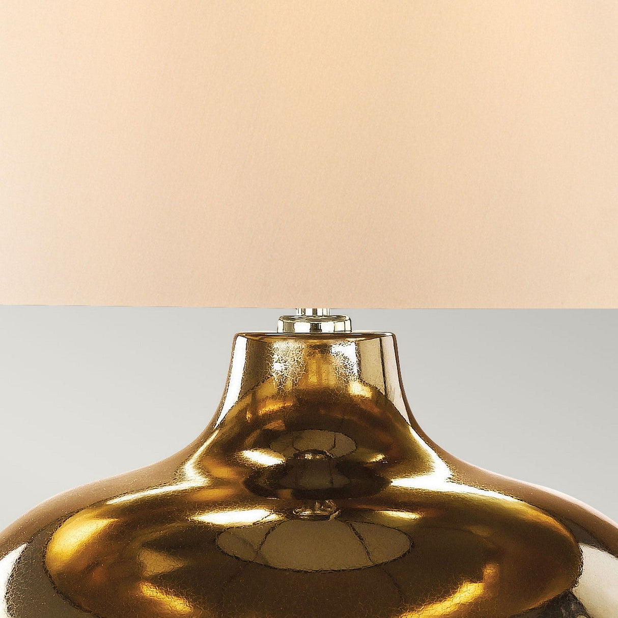 Close-up of the Ottoman 1 Light Table Lamp - Bronze Metallic/Ivory Shade, featuring a large, bronze metallic base and an ivory shade. The base boasts a smooth, glossy surface that reflects light for an elegant appearance, while the neutral background accentuates the lamp's design.