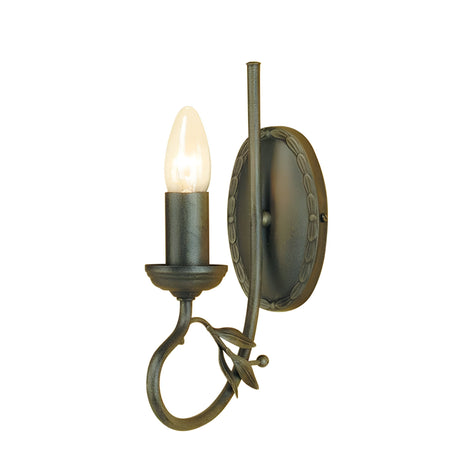 The Olivia 1 Light Wall Light - Black/Gold Patina is a decorative wall sconce featuring a single light bulb. It showcases a dark metal finish with black and gold patina, complemented by a circular base and an ornate curved arm adorned with leaf-like accents. This handmade wall light brings elegance to any space.