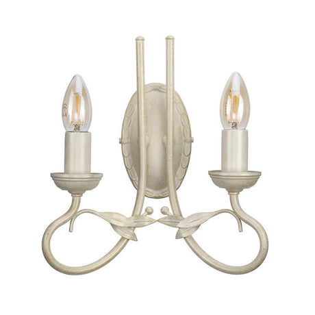 Introducing the Olivia 2 Light Wall Light in Ivory/Gold Patina, a vintage-style sconce featuring two candle-shaped LED bulbs. Its ornate metal design, adorned with cream-colored leaf and vine patterns, adds a classic and elegant touch to any setting.