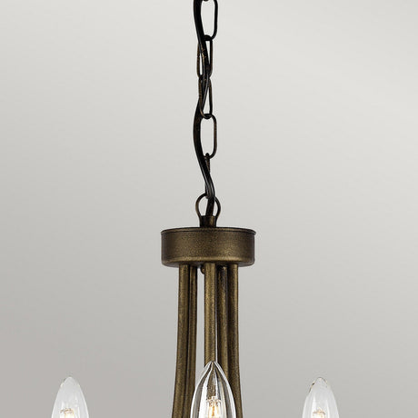 A detailed view of the Olivia 5 Light Chandelier - Black/Gold Patina showcases its handmade bronze craftsmanship. The design prominently features three exposed candle-shaped light bulbs and elegantly suspends from a decorative chain against a gentle light gray backdrop.