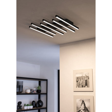 Padulari LED flush ceiling light in black, with staggered linear aluminium and steel bars and white diffusers, shown illuminated on a hallway ceiling near framed artwork.