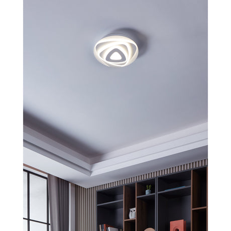 Palagiano LED flush ceiling light in white, 30cm, with layered triangular ring shade around a triangular centre, shown illuminated on a grey ceiling in a hallway setting.