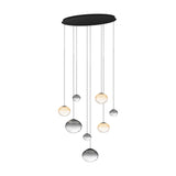Pantoja 8 Light Pendant with ribbed amber and smoke glass globes at varying heights on fine cords from a black oval steel canopy, shown on a plain white background.