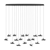 Paratebueno 17 Light Linear Pendant Light in black, oval canopy with bird-shaped shades in dark nickel finish and white diffusers, shown on a plain white background.