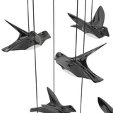 Paratebueno 17 Light Linear Pendant Light in black, close-up of bird-shaped fixtures with glossy nero finish and white diffusers, suspended on black cords against a white background.