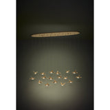 Paratebueno 2 linear pendant light with an oval brass canopy and seventeen bird-shaped shades at varying heights, illuminated with warm white LED light against a dark background.