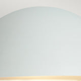 A close-up of a smooth, dome-shaped lampshade in pale blue, resembling a modern outdoor lighting piece, set against a light gray background. The bottom edge of this stylish Paris Outdoor Large 1 Light Wall Lantern - White emits a soft, warm glow.
