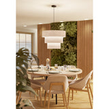 Parogno Fabric Pendant Light in black and white, three-tier cream fabric drum shades on a black steel canopy and cord, hung above a round dining table.