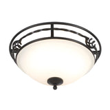 The Pembroke 2 Light Flush Light - Black is a round ceiling fixture with a frosted glass shade. Its black metal frame, made from hand-forged iron, boasts elegant decorative swirls that add a touch of sophistication.