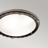 Presenting the Pembroke 1 Light Flush Light in Black/Gold: This round flush light features a textured glass surface with a decorative hand-forged iron rim. The striking black/gold finish is enhanced by twisted accents and small round details, set against a plain, soft gray background.