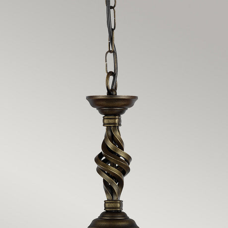 The Pembroke 1 Light Pendant in a black and gold finish, featuring a hand-forged iron design with twisted ornaments, hangs elegantly from a chain against a plain background.