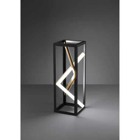 Penela LED table lamp with a tall black open rectangular frame, angled white light bars and a slim gold diagonal accent, shown against a dark grey background.