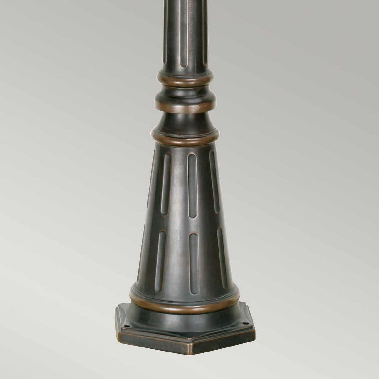 The Philadelphia 3 Light Large Lamp Post in Old Bronze boasts a grooved, tapered pedestal with a solid square base, ideal for complementing your outdoor lighting needs against a neutral backdrop.