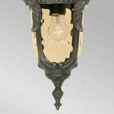 The Philadelphia 1 Light Outdoor Medium Chain Pendant showcases period-style elegance with its Old Bronze finish and clear glass shade, which reveals an exposed light bulb inside. The design is highlighted by decorative details and a pointed bottom finial, set against a neutral gradient background.