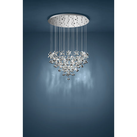 Pianopoli pendant light with clear glass flowers and chrome ball drops cascading on fine wires from a round chrome ceiling canopy, shown against a dark blue backdrop.