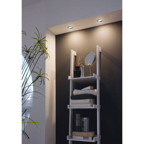 Pineda LED Downlights recessed into a ceiling above a white ladder shelf, round satin nickel bezels casting warm white light in a bathroom setting.