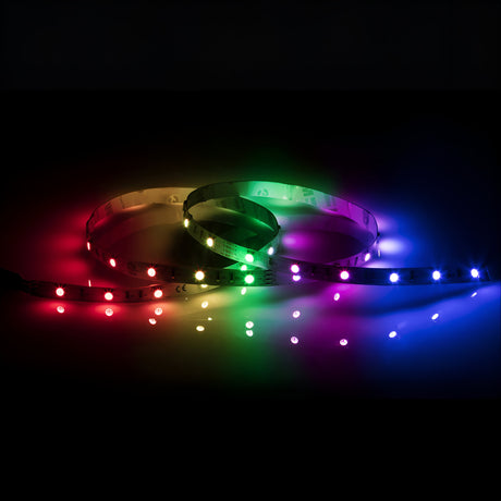 Product Description: A flexible 24V RGB LED Strip Light - 30m, featuring a vibrant display of red, green, and blue colors. The vivid glow from the individual lights on the strip is accentuated against a dark background, powered by a reliable 24V constant voltage driver.
