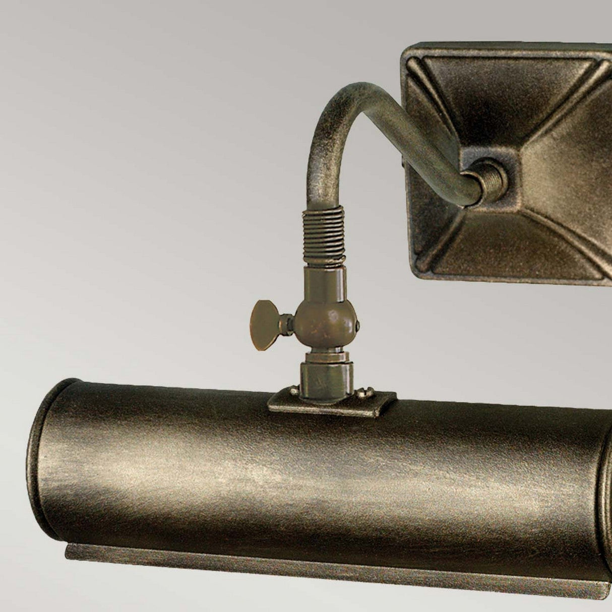 A close-up of the Picture Light 1 Light Small in black and gold showcases its vintage-style metallic design, with a cylindrical shade and an adjustable arm, set against a plain background. This wall-mounted fixture features industrial design elements, including visible screws and a rotary switch, making it perfect for illuminating artwork.