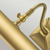 Close-up of the Picture Light 2 Light Large in brushed brass, showcasing its cylindrical lamp body attached to a flexible arm and square base, all in a coordinated metallic finish. This fixture exudes elegance and is ideal for illuminating art as a picture light against a neutral background.