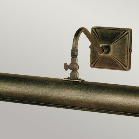 The Picture Light 2 Light Large - Black/Gold is a bronze wall-mounted fixture featuring a curved arm and a square base, expertly crafted to illuminate artwork or photographs. Available in sophisticated black and gold finishes, it adds elegance while providing adjustable lighting for an ideal display.