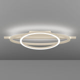 Planillo LED Flush Ceiling Light in Sand, featuring a circular ring, elliptical ring and straight bar in sand aluminium and steel, mounted on a rectangular ceiling plate against a grey background.