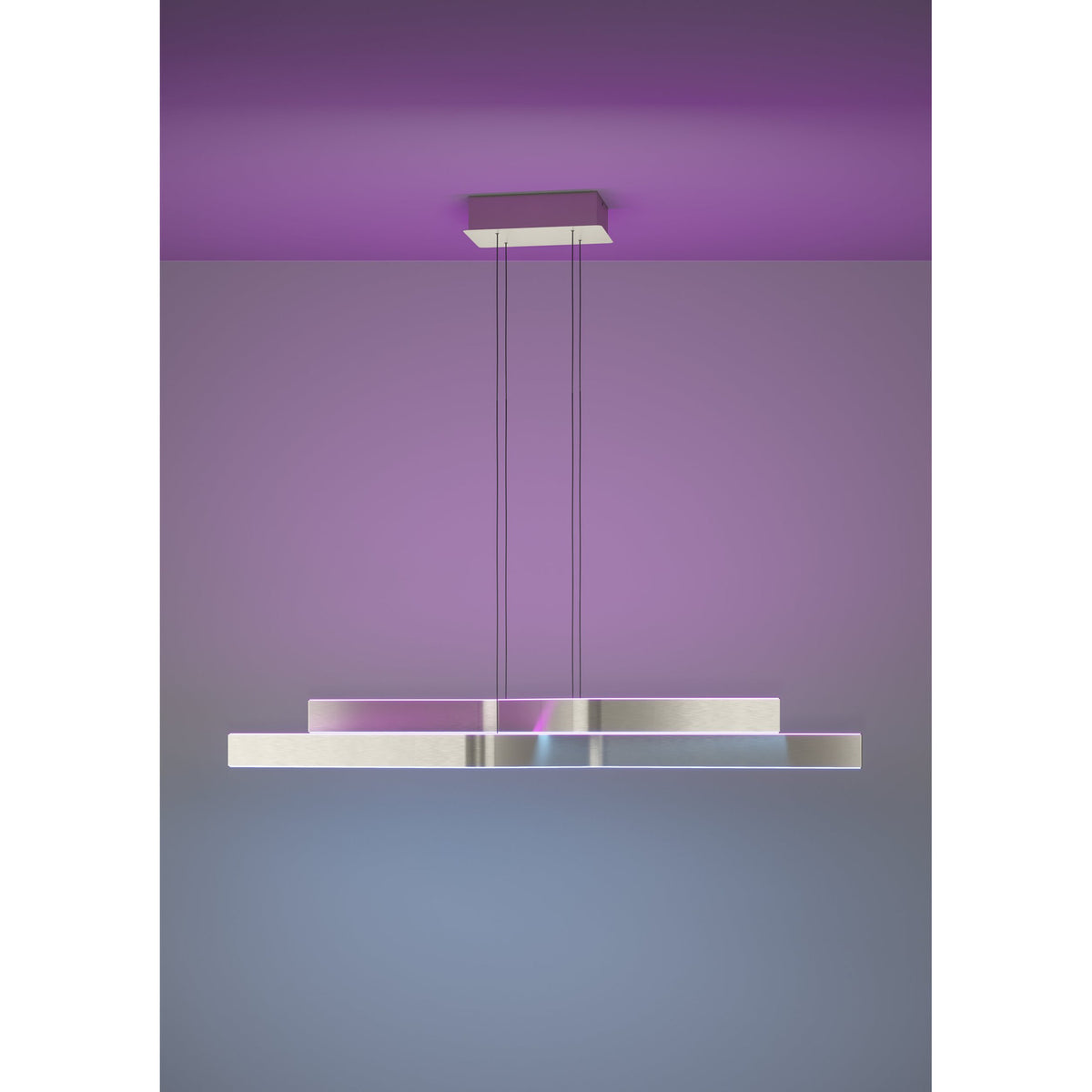 Playitas Pendant Light in satin nickel, a long linear LED fixture with two offset aluminium and steel bars suspended on thin wires, shown glowing RGB purple against a matching ceiling and wall.