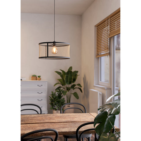 Polbena Pendant Light in black steel with brass-toned diamond mesh drum shade and exposed E27 bulb, hanging above a wooden dining table in a living space.