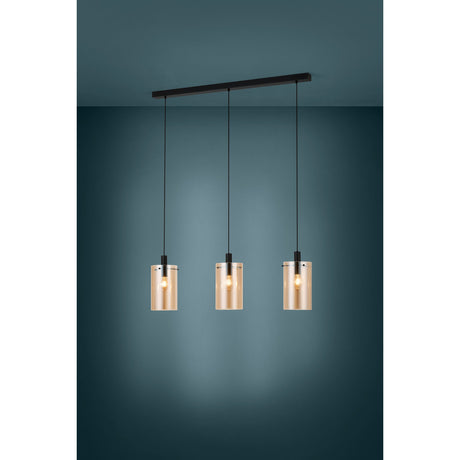 Polverara linear pendant light with three cylindrical amber glass shades suspended from a black ceiling bar, shown against a dark teal wall.